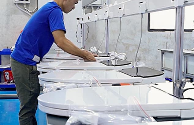 Technician assembling smart toilet components on the production line.
